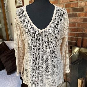 Cream-colored top or bathing suit cover-up